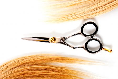 scissors and lock of hair isolated on white